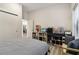 A well-lit bedroom with a view into the kitchen, a closet, shelving, and a bench by the window at 112 Rogers Ne St # 206, Atlanta, GA 30317