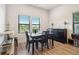 Dining room with a modern table, dark wood furniture, and two windows providing natural light at 112 Rogers Ne St # 206, Atlanta, GA 30317