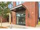 Building entrance at 112 with brick facade, modern glass doors, and visible street-side details at 112 Rogers Ne St # 206, Atlanta, GA 30317