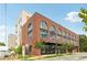 Brick exterior with arched windows showcases architecture, complemented by the building's well-maintained street view at 112 Rogers Ne St # 206, Atlanta, GA 30317