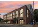 Stylish brick apartment building featuring arched windows and street-level parking at 112 Rogers Ne St # 206, Atlanta, GA 30317