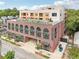 Attractive apartment building with a rooftop deck, brick facade, and streetscape at 112 Rogers Ne St # 206, Atlanta, GA 30317