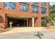 View of an entrance of covered parking inside a brick building at 112 Rogers Ne St # 206, Atlanta, GA 30317