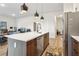 Modern kitchen featuring an island with sink and stainless steel appliances, adjacent to open living area at 112 Rogers Ne St # 206, Atlanta, GA 30317