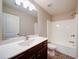 Bathroom featuring a vanity with a sink and a shower-tub combination with white tile surround at 4280 Hunters Walk Way, Cumming, GA 30028