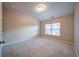 An empty bedroom includes carpeted floors, a window providing natural light, and neutral wall paint at 4280 Hunters Walk Way, Cumming, GA 30028