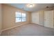 Bright bedroom featuring carpet floors, a window, and a closet with double doors at 4280 Hunters Walk Way, Cumming, GA 30028