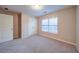 Bedroom featuring carpet floors, a window, and a closet with double doors at 4280 Hunters Walk Way, Cumming, GA 30028