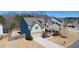 Aerial view of a two-story home with beautiful architecture, a driveway, and a green lawn at 4280 Hunters Walk Way, Cumming, GA 30028