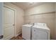 Laundry room featuring new washer and dryer units with wire shelving for storage at 4280 Hunters Walk Way, Cumming, GA 30028