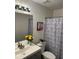 Cozy bathroom with flowers, modern vanity, and patterned shower curtain at 2586 Abbotts Glen Dr, Acworth, GA 30101