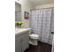 Bathroom features a modern vanity, toilet, and shower with a patterned curtain at 2586 Abbotts Glen Dr, Acworth, GA 30101