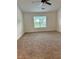 Spacious bedroom featuring neutral carpeting, a ceiling fan, and a window overlooking the outdoors at 2586 Abbotts Glen Dr, Acworth, GA 30101