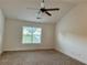 Bedroom featuring neutral carpeting, vaulted ceiling with a ceiling fan and a window overlooking the outdoors at 2586 Abbotts Glen Dr, Acworth, GA 30101