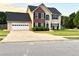 Charming two-story home boasts a brick-accented facade and attached garage at 2586 Abbotts Glen Dr, Acworth, GA 30101