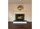 Living room fireplace with decorative mantel and horse artwork at 2586 Abbotts Glen Dr, Acworth, GA 30101