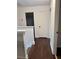 Upstairs hallway featuring hardwood floors and white doors at 2586 Abbotts Glen Dr, Acworth, GA 30101