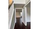 Hallway with hardwood flooring leading to a room with a window at 2586 Abbotts Glen Dr, Acworth, GA 30101