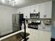 Elegant kitchen with stainless steel appliances, white cabinetry, and quartz countertops at 2586 Abbotts Glen Dr, Acworth, GA 30101