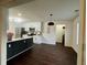 Open concept kitchen with stainless steel appliances, a dark island, and a view into the dining area at 2586 Abbotts Glen Dr, Acworth, GA 30101