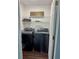 Well-organized laundry room with modern black washer and dryer and wire shelving at 2586 Abbotts Glen Dr, Acworth, GA 30101