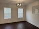 Well-lit room featuring hardwood floors, two windows and modern light fixture at 2586 Abbotts Glen Dr, Acworth, GA 30101