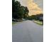 Residential street view with parked cars and trees, showcasing a peaceful neighborhood setting at 2586 Abbotts Glen Dr, Acworth, GA 30101