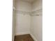 Walk-in closet featuring wall-mounted wire shelving and neutral carpeting at 2586 Abbotts Glen Dr, Acworth, GA 30101