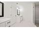Well-lit bathroom with double vanity sinks and a glass-enclosed shower at 3555 New Hope Rd, Dacula, GA 30019