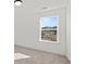 Bright bedroom with a large window showcasing a peaceful outdoor view at 3555 New Hope Rd, Dacula, GA 30019