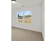 Carpeted bedroom with large window and neutral paint at 3555 New Hope Rd, Dacula, GA 30019