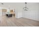 Open dining area with wainscotting, an elegant chandelier and hardwood flooring at 3555 New Hope Rd, Dacula, GA 30019