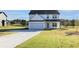 View of the home's exterior with a long driveway and well-manicured front lawn at 3555 New Hope Rd, Dacula, GA 30019