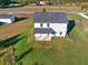 Aerial view of the home's rear exterior with covered patio and landscaped lawn at 3555 New Hope Rd, Dacula, GA 30019