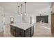 Open-concept kitchen with an island that opens into the dining and Gathering room at 3555 New Hope Rd, Dacula, GA 30019
