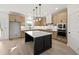 Well-lit kitchen featuring a large island, stainless steel appliances, and light wood cabinets at 3555 New Hope Rd, Dacula, GA 30019