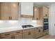 Close-up of a gas range with stainless steel appliances and a white backsplash at 3555 New Hope Rd, Dacula, GA 30019