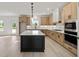 Modern kitchen featuring an island, stainless steel appliances, and light wood cabinets at 3555 New Hope Rd, Dacula, GA 30019