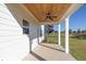 Covered porch with wooden ceiling, fan, and white columns overlooking the yard at 3555 New Hope Rd, Dacula, GA 30019
