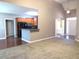 Open living room featuring hardwood and carpet flooring, modern lighting, and half wall to kitchen at 405 Clarion Dr, Carrollton, GA 30116