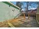 Exterior view of wooden back deck with railings and green siding at 1474 Athens Avenue Sw Ave, Atlanta, GA 30310