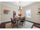 Spacious dining room features hardwood floors, decorative chandelier, and views of kitchen at 1474 Athens Avenue Sw Ave, Atlanta, GA 30310