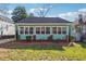 Charming single-story home featuring light green siding, white trim, and a well-manicured front yard at 1474 Athens Avenue Sw Ave, Atlanta, GA 30310
