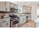 Updated kitchen features stainless steel appliances, gray cabinets, and neutral countertops at 1474 Athens Avenue Sw Ave, Atlanta, GA 30310
