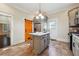 This kitchen features granite countertops, a center island, stainless steel refrigerator and an orange barn door at 1474 Athens Avenue Sw Ave, Atlanta, GA 30310