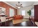 Comfortable living room with brick accent wall, desk, and neutral-toned furniture at 1474 Athens Avenue Sw Ave, Atlanta, GA 30310