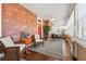 Inviting sunroom with brick walls, tile floors, and comfortable seating, perfect for relaxation at 1474 Athens Avenue Sw Ave, Atlanta, GA 30310