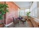 Cozy sunroom with brick walls, neutral color furniture, and a bright and airy atmosphere at 1474 Athens Avenue Sw Ave, Atlanta, GA 30310