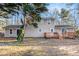 Backyard of a tan two-story home featuring a wooden deck and sliding glass doors at 170 Charlotte Blvd, Stockbridge, GA 30281