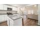 Well-lit kitchen with granite countertops, stainless steel appliances, and island with barstool seating at 170 Charlotte Blvd, Stockbridge, GA 30281